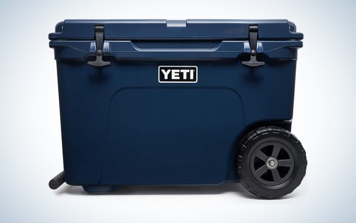  A navy Yeti Tundra Haul wheeled cooler is placed against a white background.