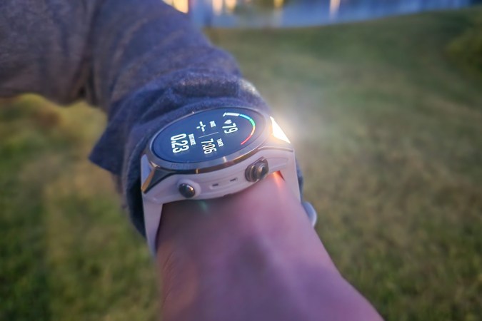  A Garmin epix 2 Pro is worn on a wrist, with its flashlight shining.