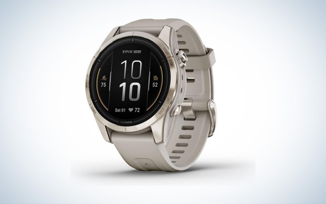 A tan and soft gold Garmin epix Pro Sapphire is place in front of a white background with a gray gradient.