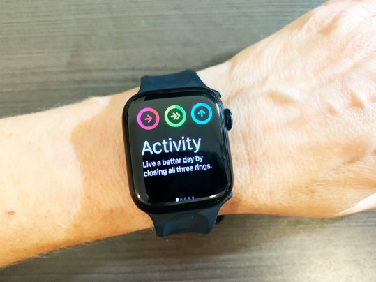 A black Apple Watch Series 8 showing three activity rings that should be completed each day.