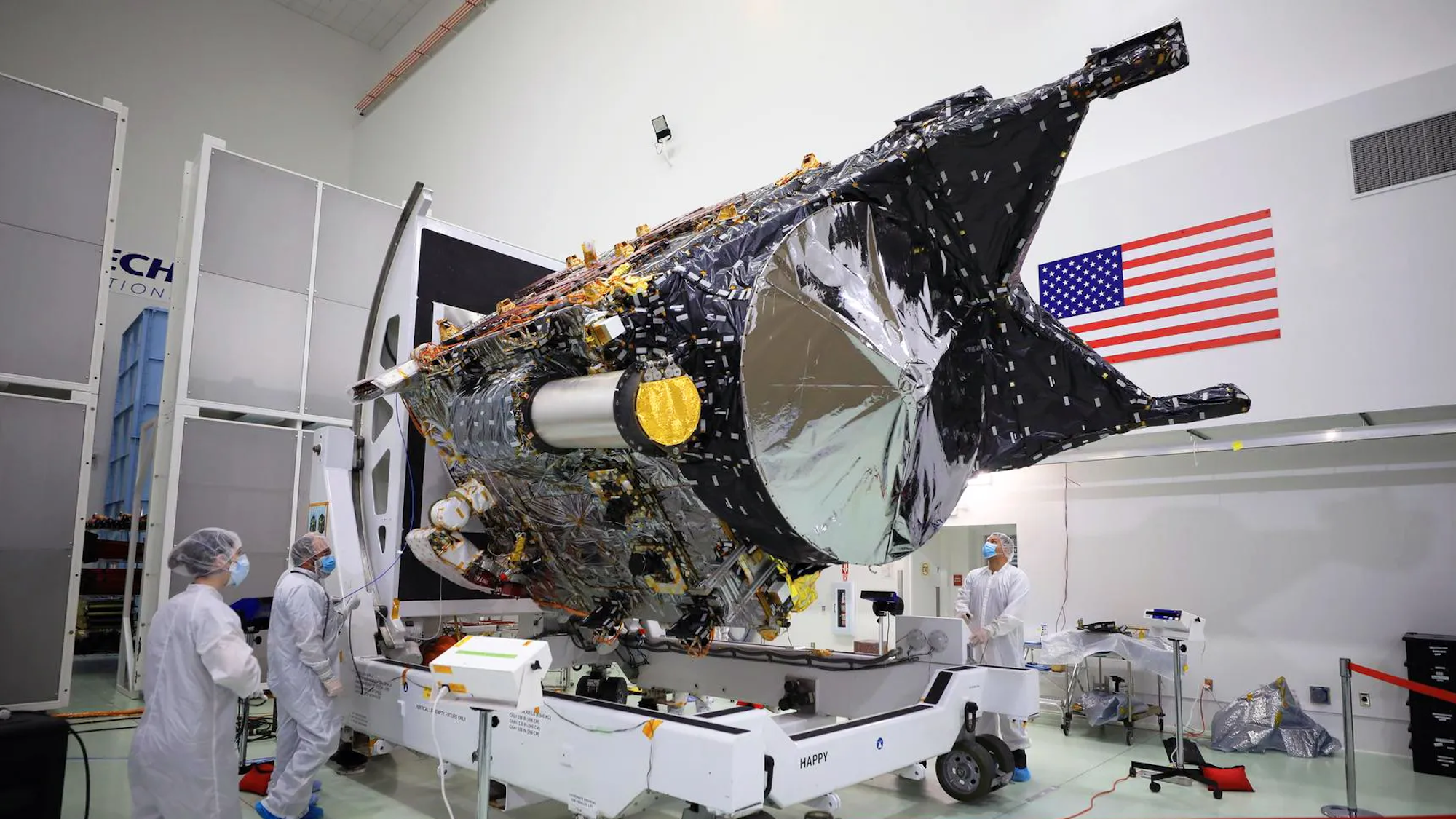 NASA Psyche spacecraft surrounded by engineers in lab