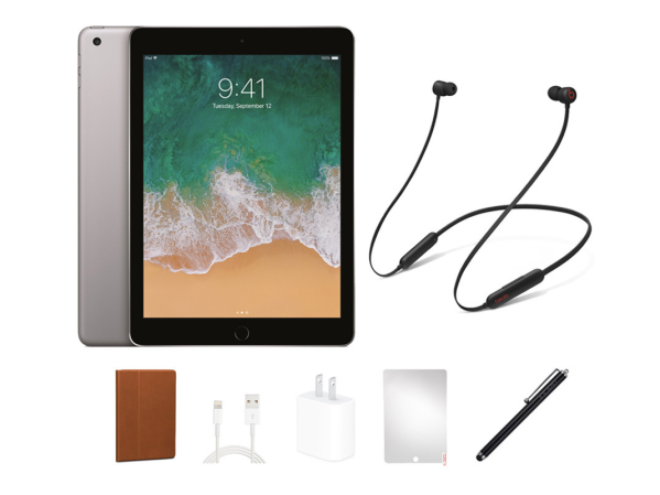 An iPad and Beats Flex headphones on a plain background