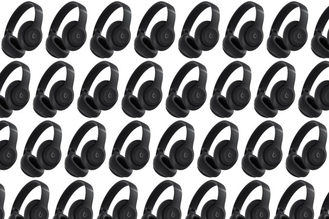 A black pair of Beats studio pro headphones in a pattern on a plain background