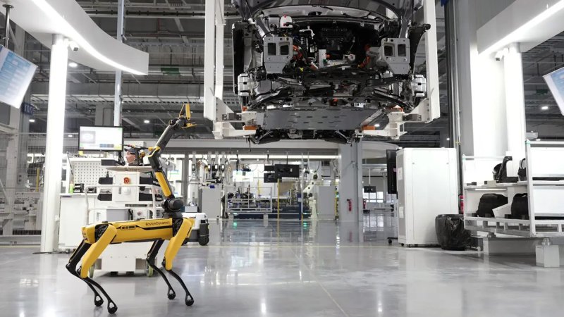 Robot dog at Hyundai factory working on car