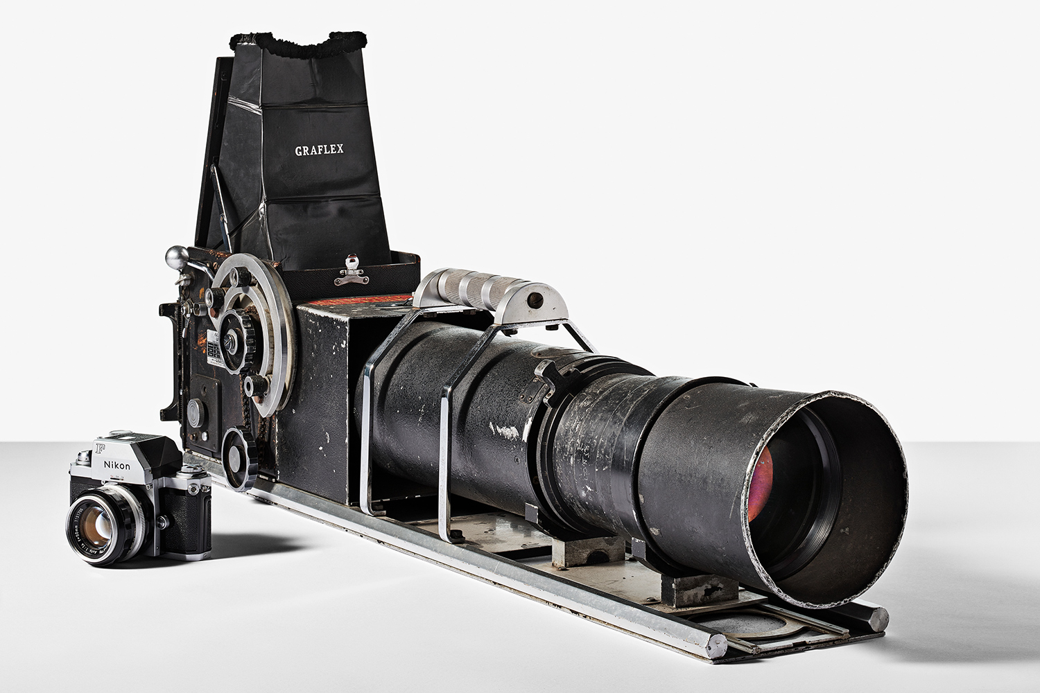 a vintage camera that would have been used to take photos of baseball players in action, isolated on a background