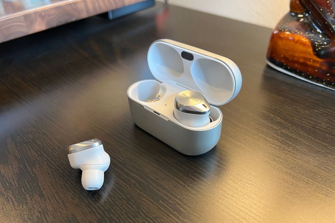  White and silver Technics AZ80 earbuds for small ears on a wood table