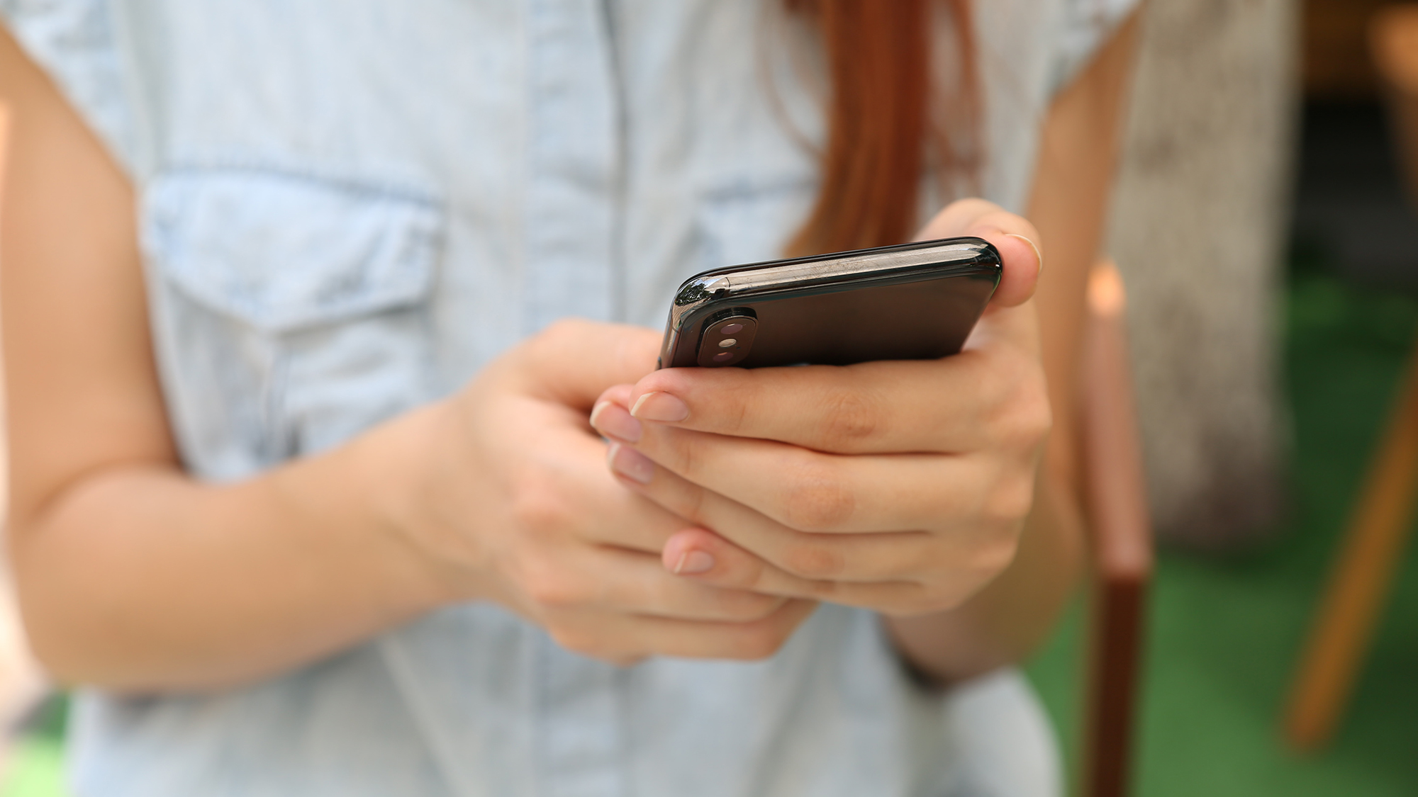 Person checking their phone and reading about 7 tips to help you become an Apple Reminders expert