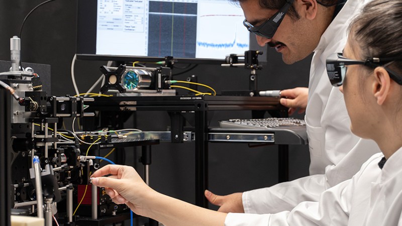 Researchers working with laser array in lab