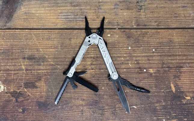 A Gerber Gear Center-Drive Multitool Bit Set on a plain wooden table.