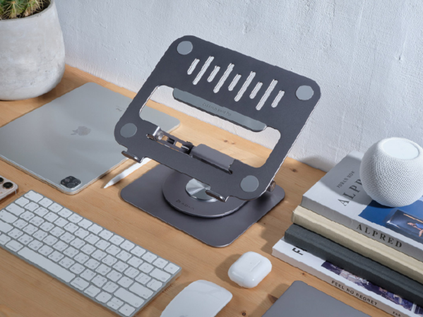 A laptop stand on a wooden desk