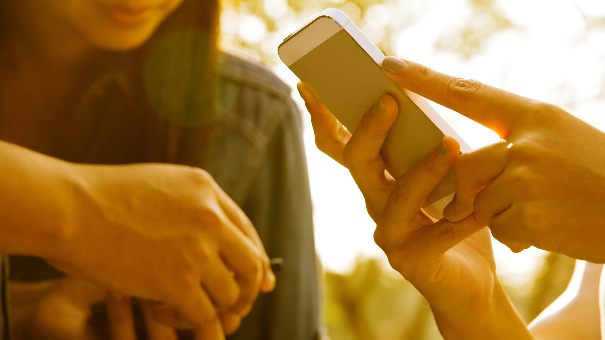 Close up of teens with smartphone