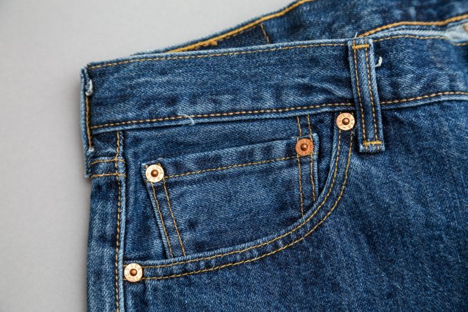 Levi's 501 fifth pocket and regular pocket on a plain background