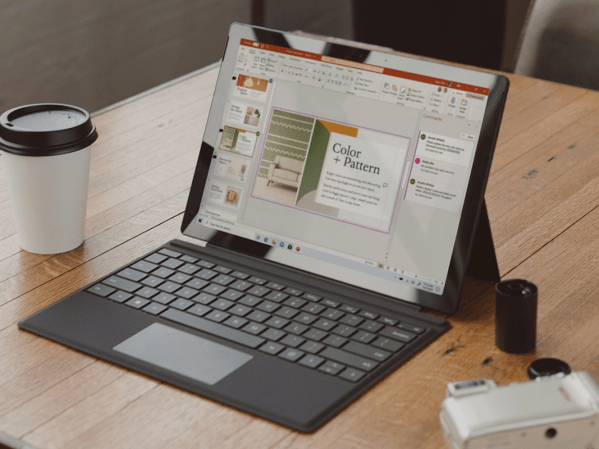 Microsoft Office Powerpoint pulled up on a Microsoft Surface on a desk.