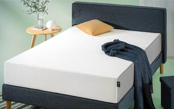  A ZINUS 12 Inch Cooling Essential Foam Mattress on a bed