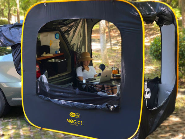 A person sitting in a pop-up tent on a plain background.