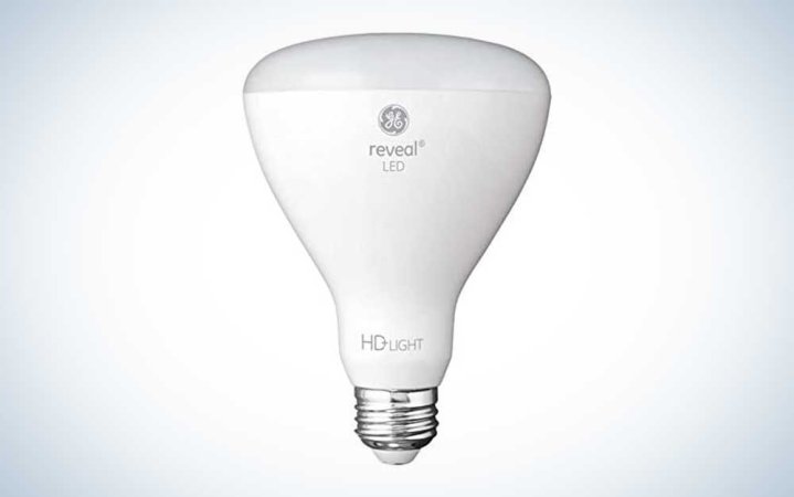  A white GE Reveal LED light bulb for for recessed lights on a plain background.