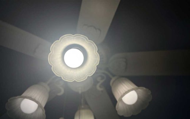 A Sylvania LED light bulb in a ceiling fan light socket.