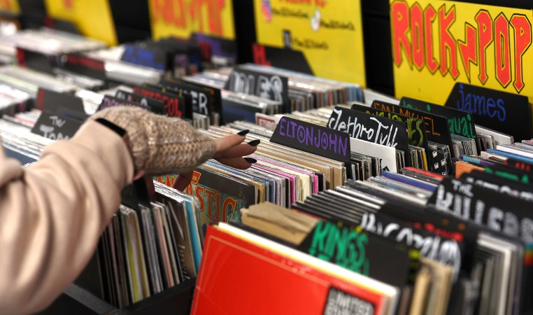 Hand flipping through vinyl records at store