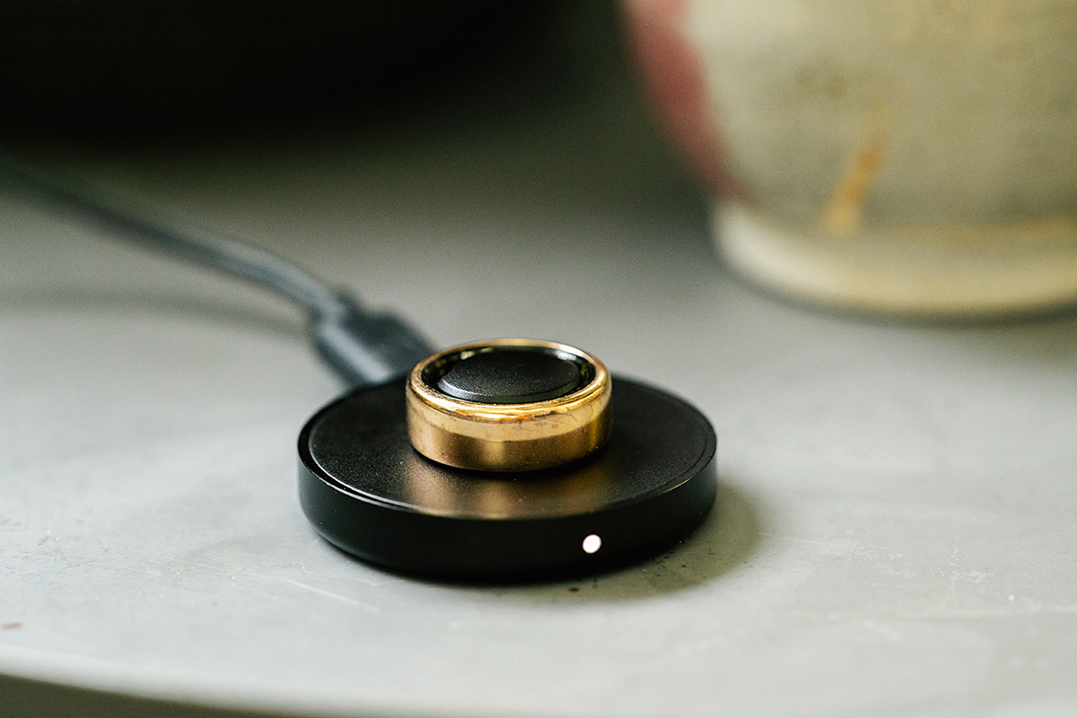 The Ora Ring Heritage on top of its charging stand.