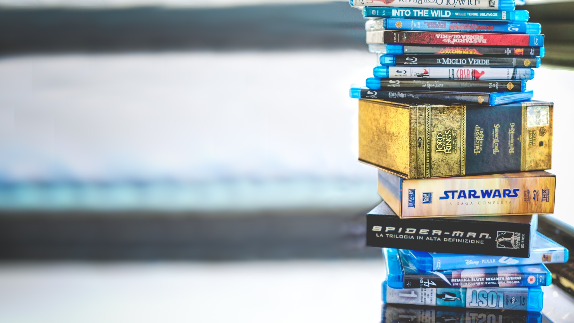 stack of blu ray discs on a reflective table