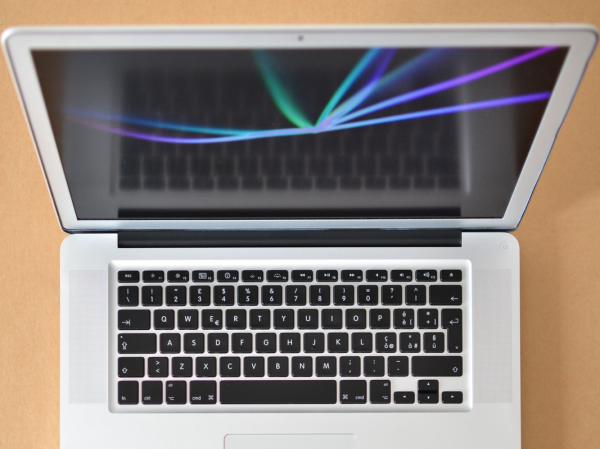 A refurbished MacBook Air on a wooden desk.