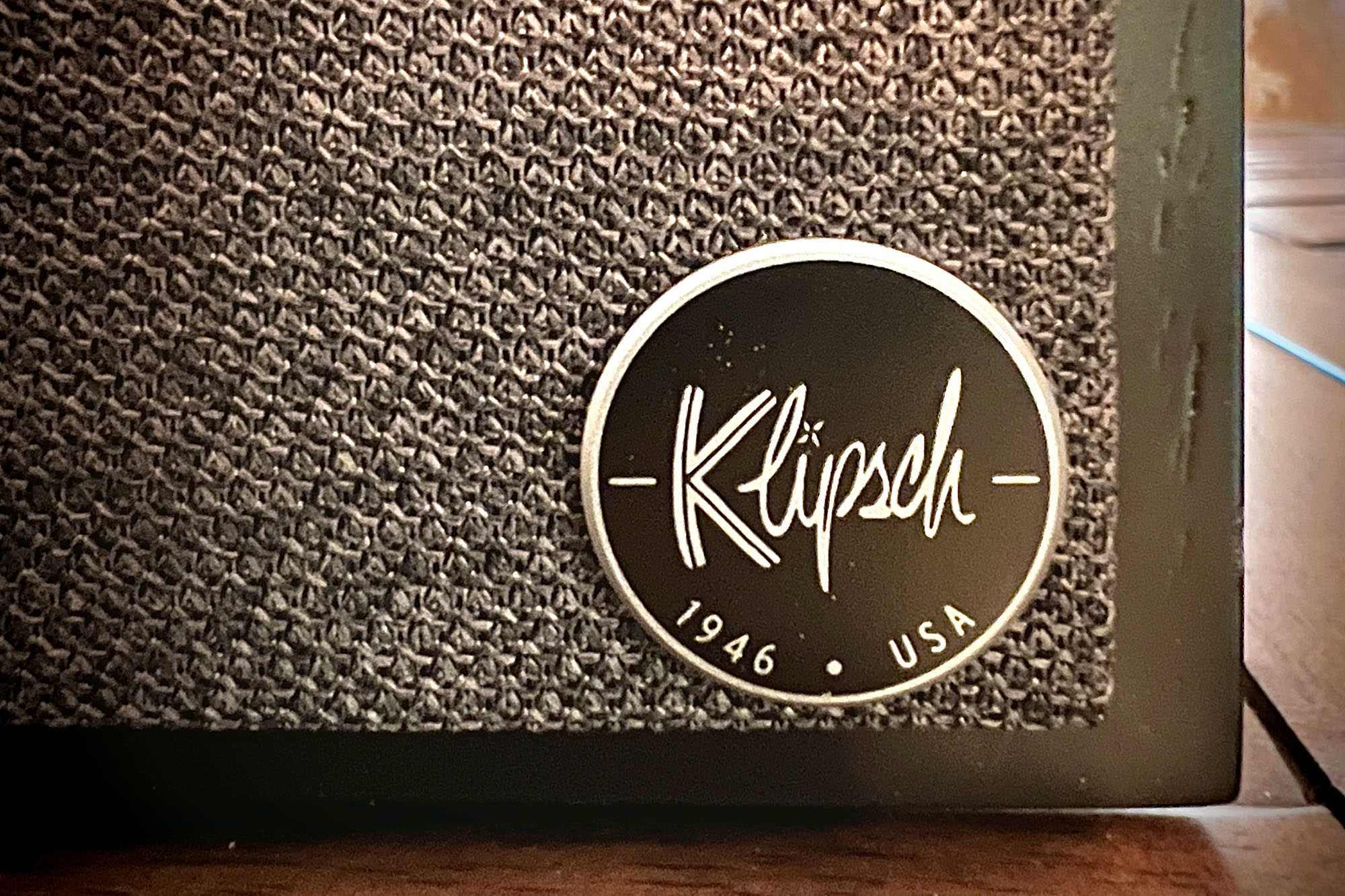 Round Klipsch logo shown on a fabric speaker covering