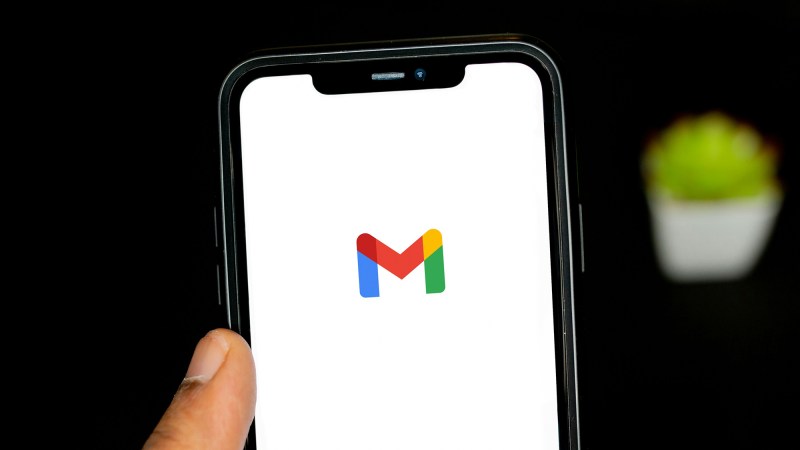 the gmail icon on an iphone in someone's hand