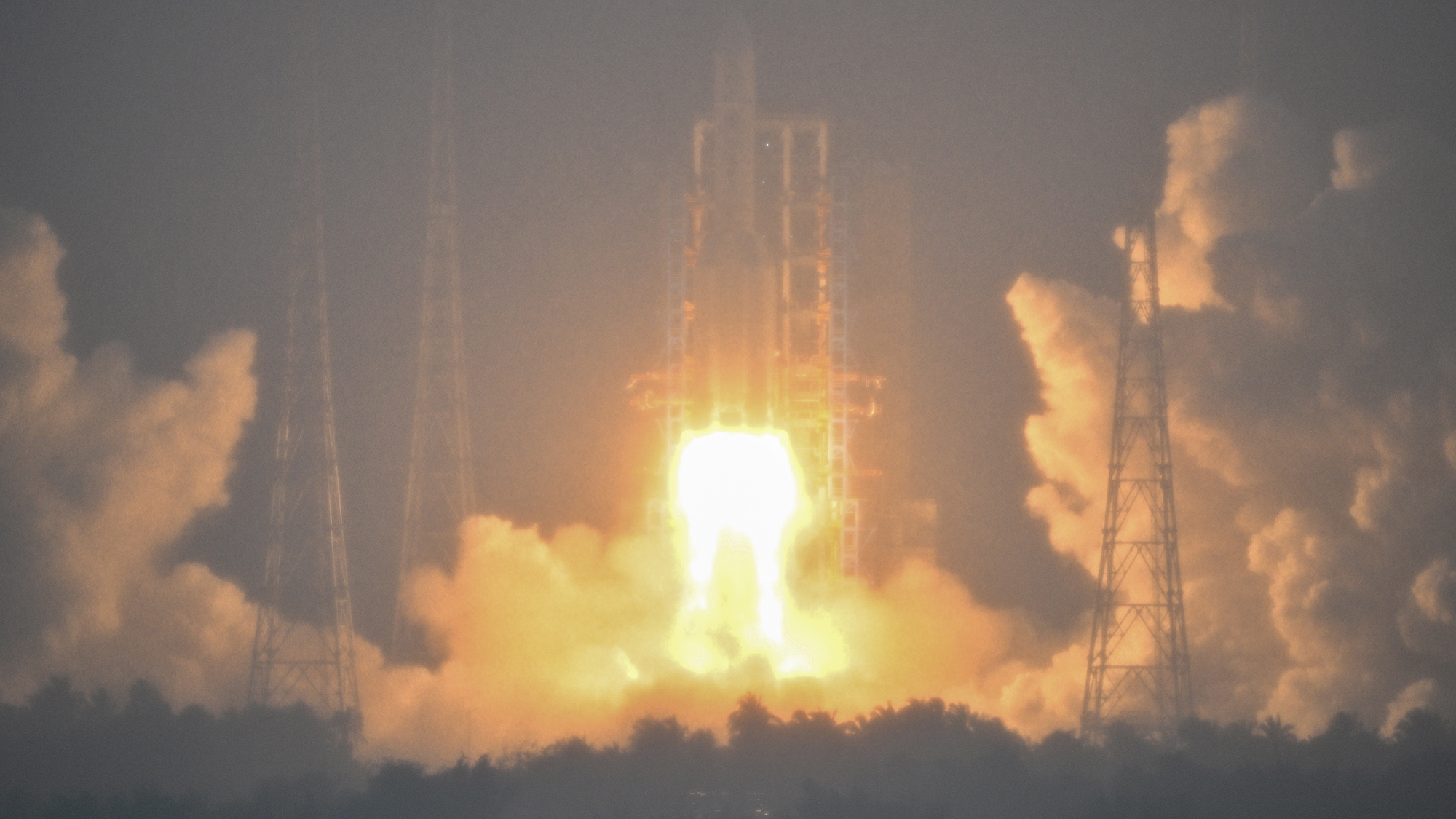 A Long March 5 rocket, carrying the Chang'e-6 mission lunar probe, lifts off as it rains at the Wenchang Space Launch Centre in southern China's Hainan Province on May 3, 2024.