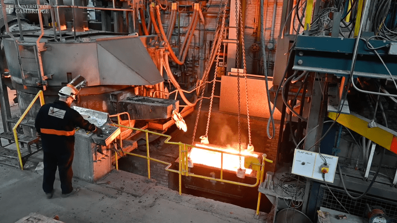 Factory worker overseeing steel forge