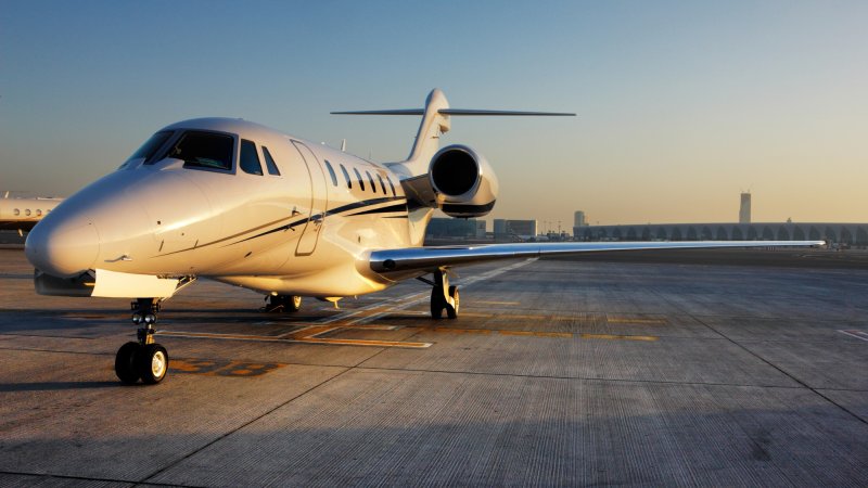 Private jet on tarmac at sunset