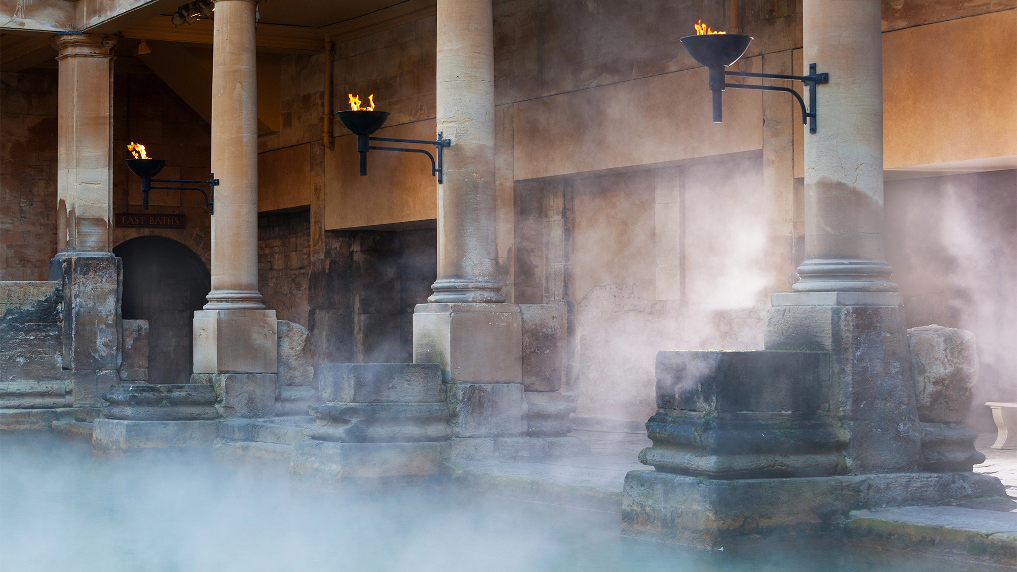 steam rising over blue water in a pool built by ancient romans