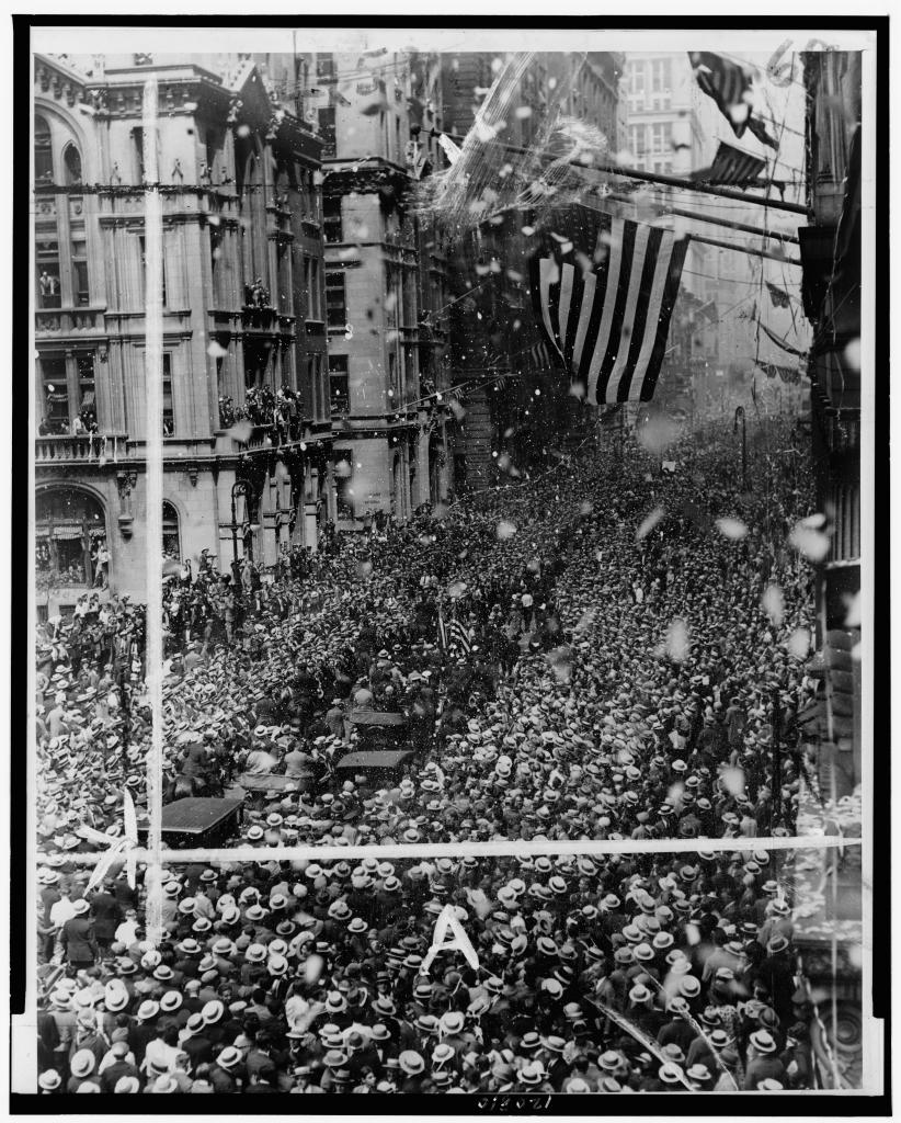 Parade for Gertrude Ederle coming up Broadway, New York City, with large crowd watching, 1926.