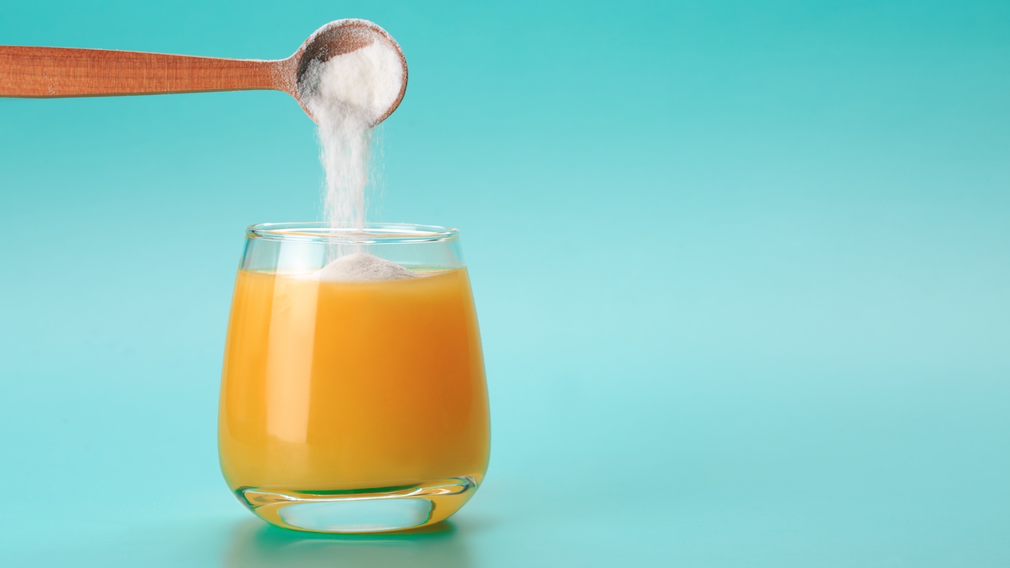 Orange juice with spoon of collagen