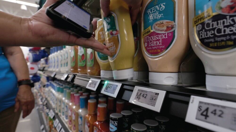 a grocery store shelf with electronic price tags