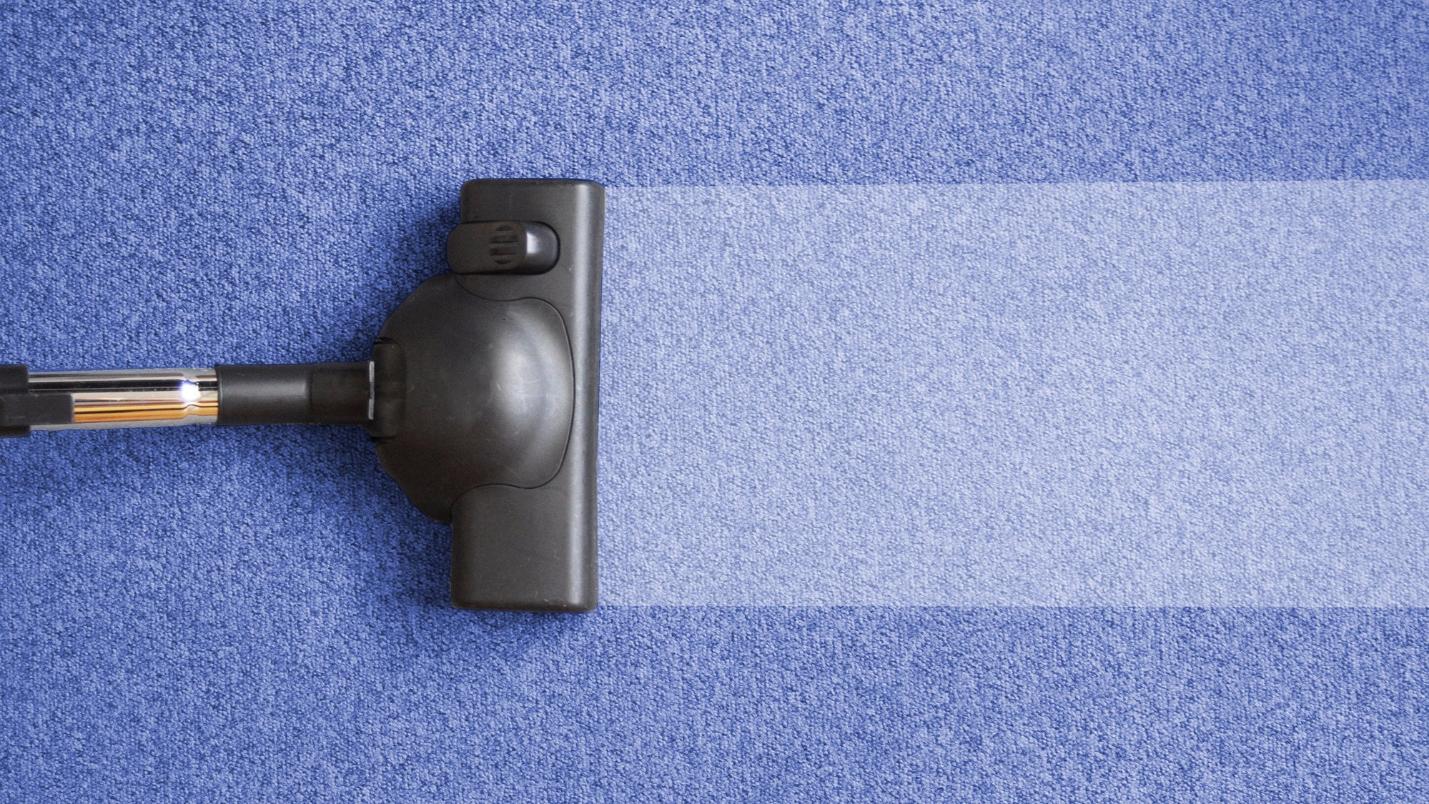 vacuum on blue carpet