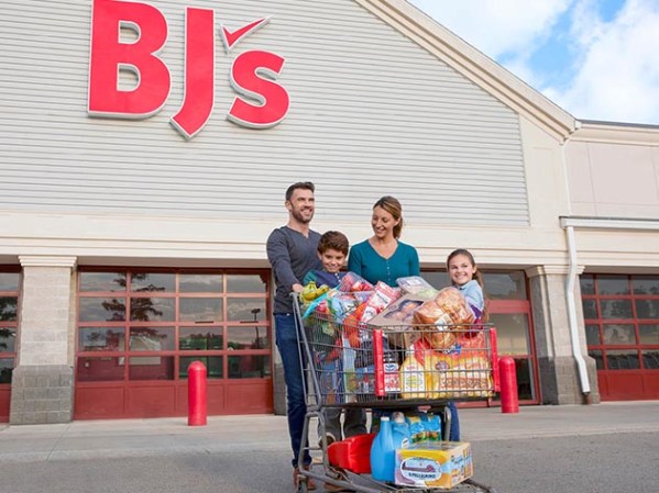 A family with a full shopping cart leaving BJ's