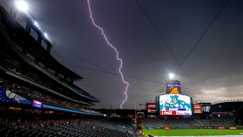 Baseball fans clear the stands as lightning strikes near the Colorado Rockies’ stadium in 2019.