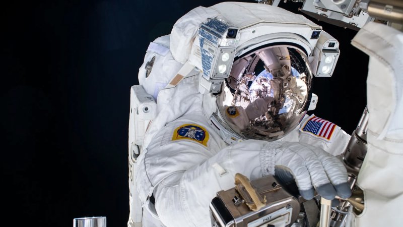 Astronaut conducting spacewalk outside ISS