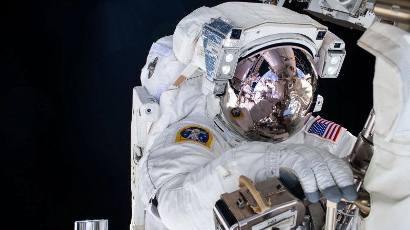 Astronaut conducting spacewalk outside ISS