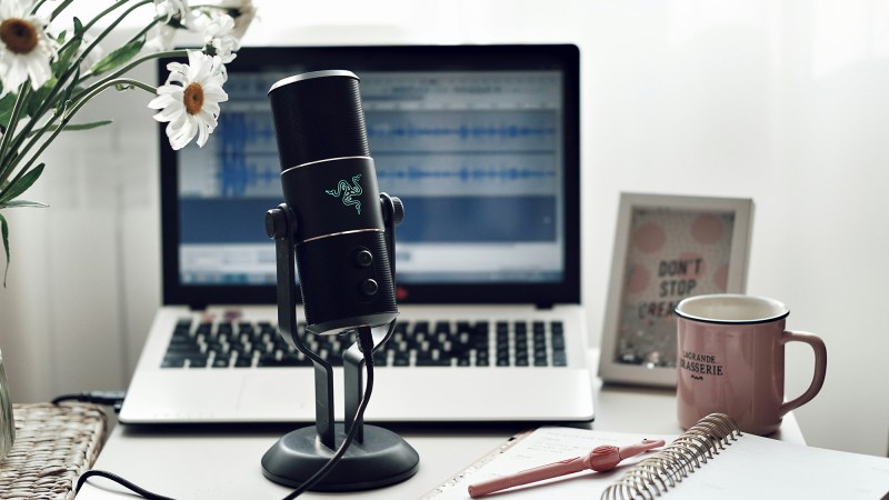 a microphone in front of a laptop on a desk