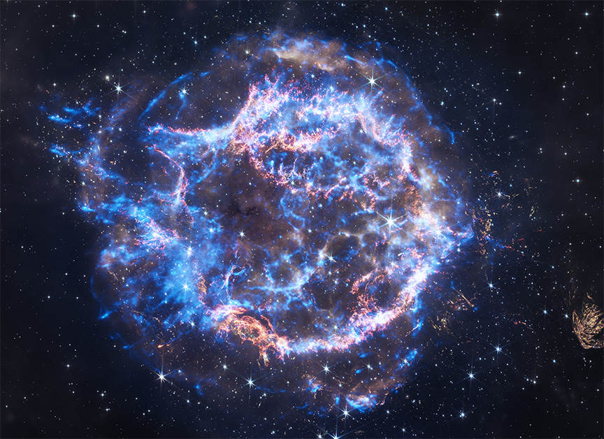 rings of neon blue and brilliant white emit veins of polished gold. The rings and their arching veins encircle a place of relative calm at the center of the supernova remnant