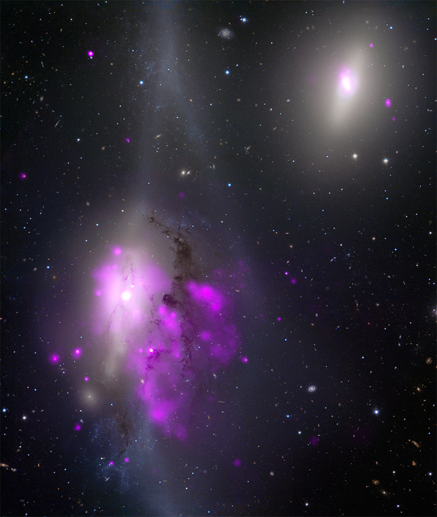 The galaxy sits in the center of a glowing white streak, at the heart of a misty white pool. Flecks of white and neon purple speckle the image, set against the blackness of space