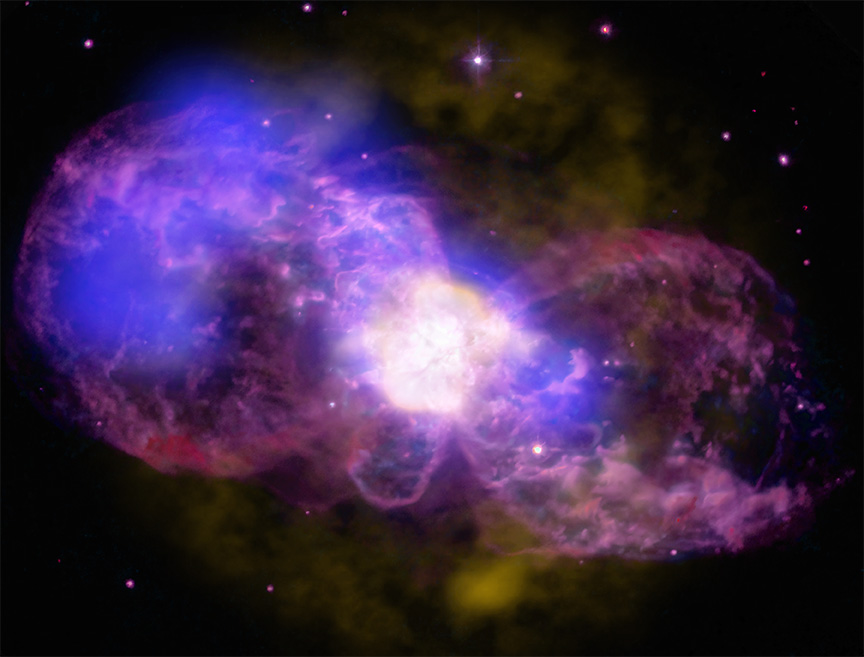 composite image of the planetary nebula HB 5 resembles a bulbous bow tie in mottled purples. At the heart of the nebula, or the knot of the bow tie, is a brilliant golden white explosion. 