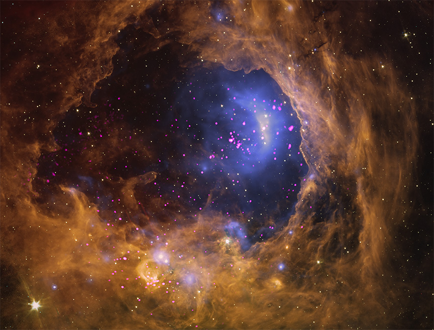 two star clusters, viewed through a churning tunnel of golden cloud. The cloud creates a border around the entire image, like a thick swirling smoke ring. 