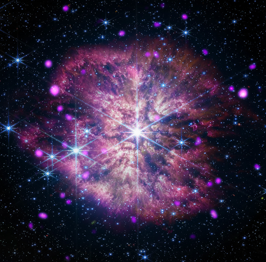 a bright, massive star, WR 124, gleams with diffraction spikes, surrounded by a churning wind cloud in reds and purples. With its dusty rose coloring, and the bright, gleaming star at its core, the wind cloud resembles the inside of a delicate flower with opening petals. 