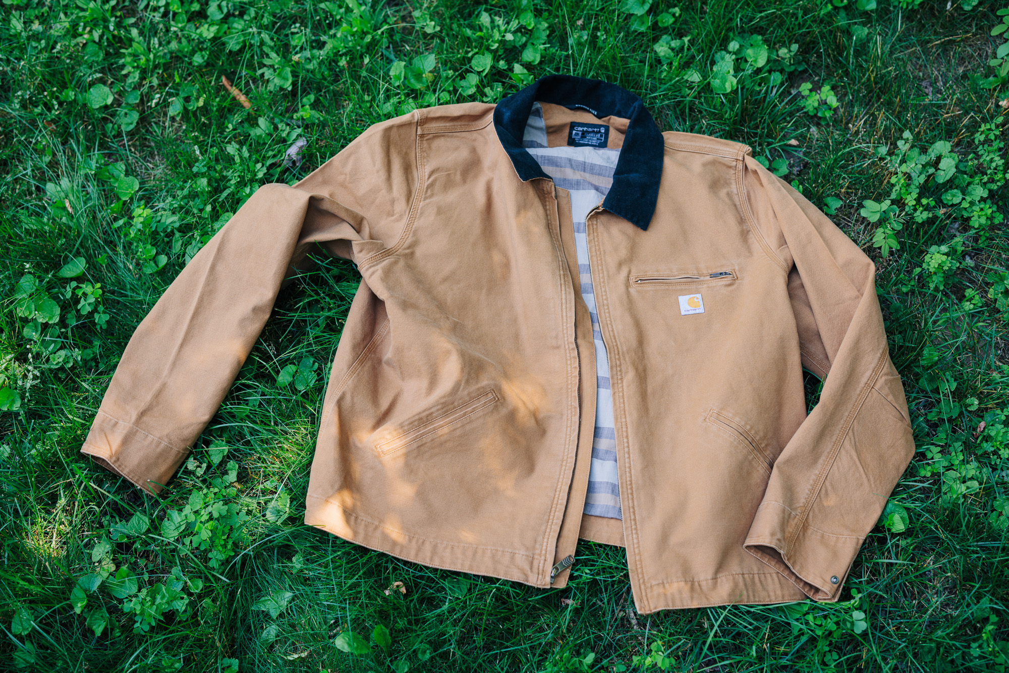 Carhartt Detroit Re-Engineered jacket laying on some grass