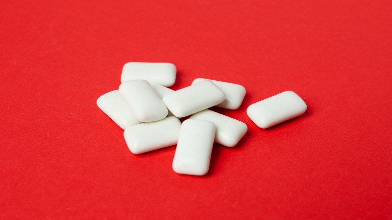 chewing gum pieces on red background