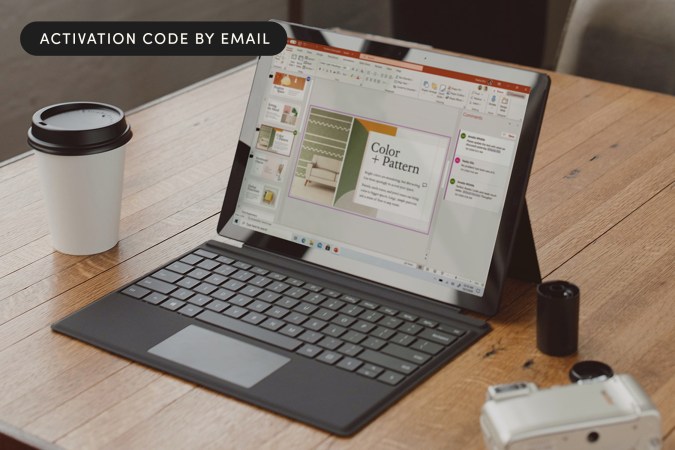 A laptop sitting on a desk with Microsoft open.