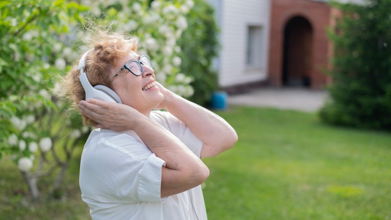 Elderly woman listening to music happily