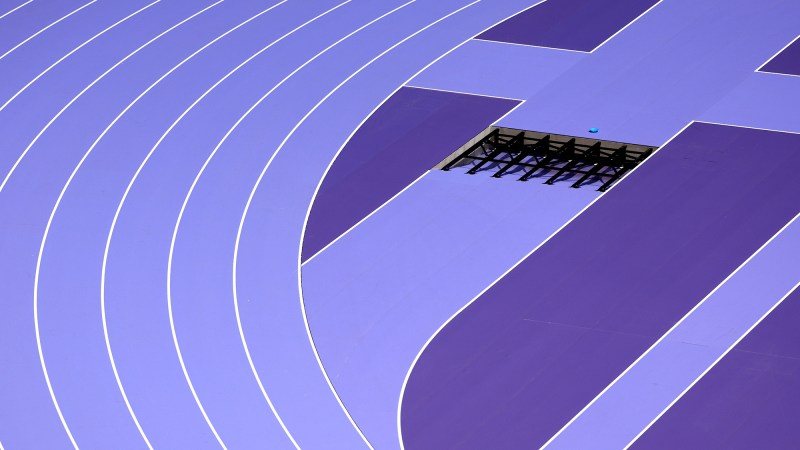 a purple race track, with whit lane lines